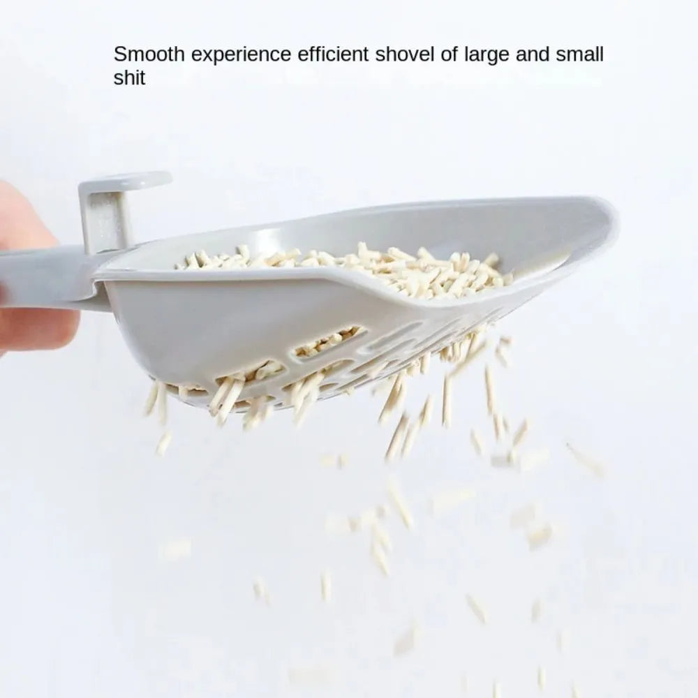 Grey plastic cat litter scoop resting in its matching plastic storage base