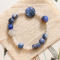 Hand-woven unisex bracelet with blue point stone and black hair crystal agate in a geometric design.