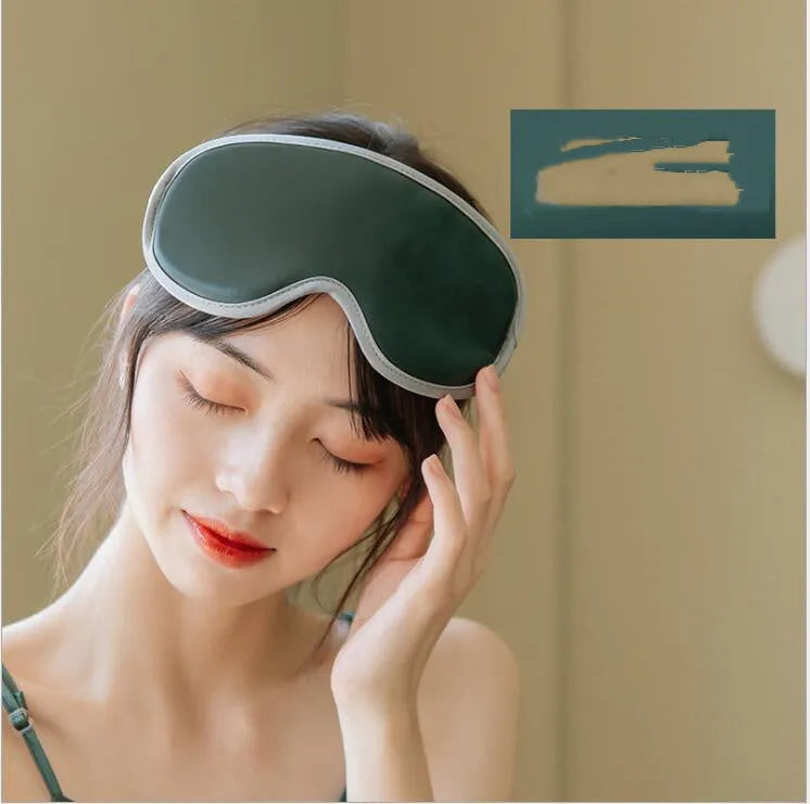 Pink or green portable steam sleep massage goggles with USB cable on a grey background.