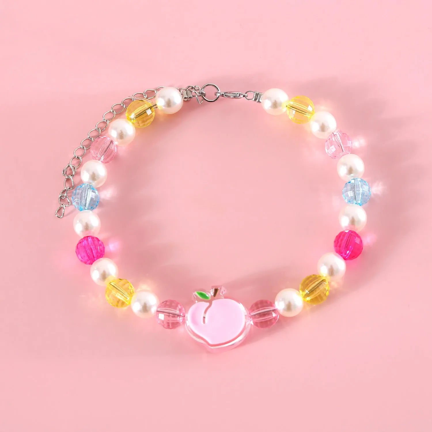 Colourful plastic bead cat necklace on a white background, showing peach, rainbow, and small flower pattern options.