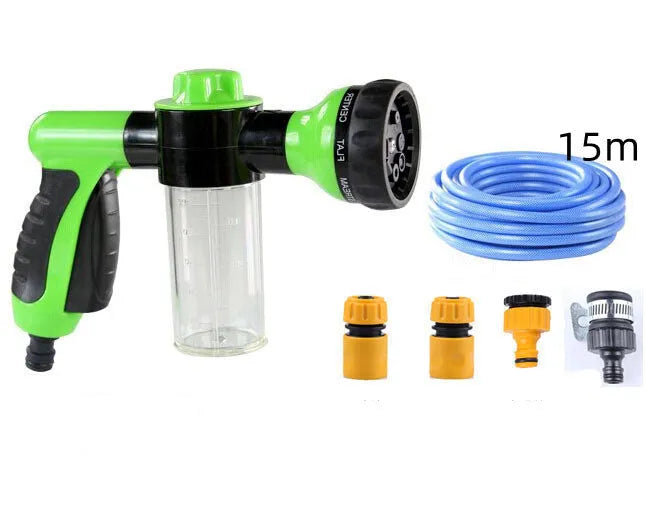 Green high-pressure foam spray gun with adjustable nozzle and attached water hose for car and garden cleaning.