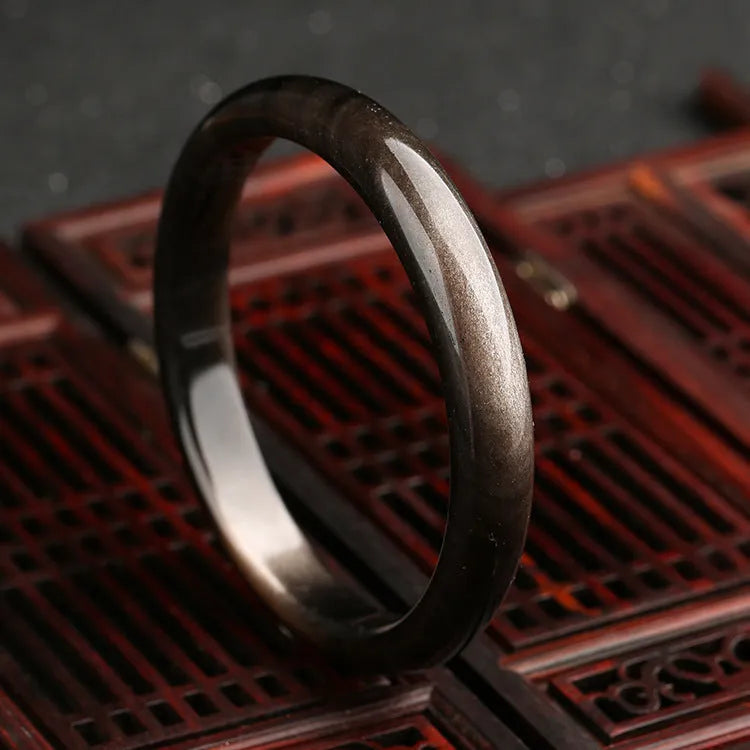Close-up of a retro-style Cat's Eye Bracelet with Natural Silver Stone crystals and geometric alloy details.