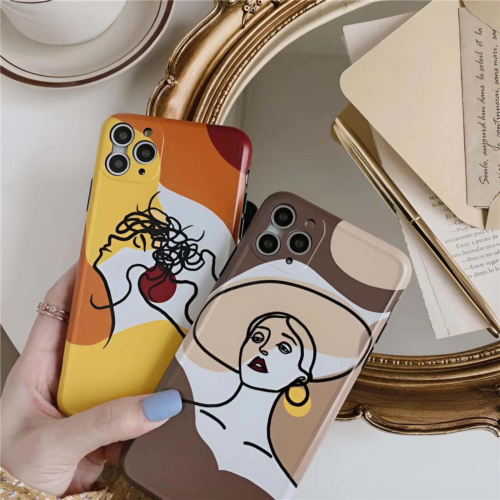 Orange yellow soft silicone iPhone case with cartoon line art graphic, shown fitted to an iPhone.