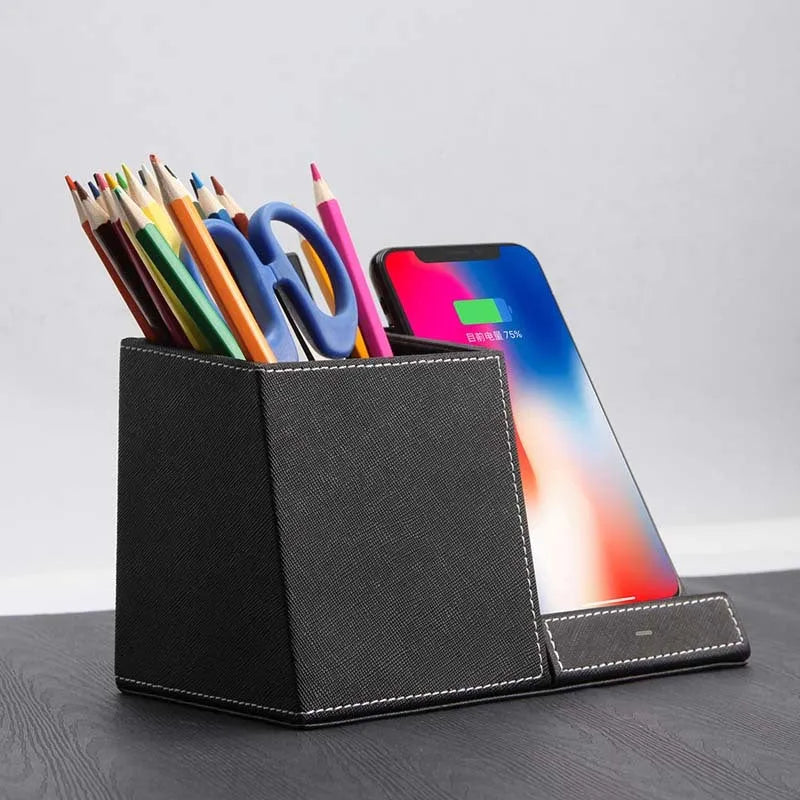 Black leather desk organiser with pen slots and a wireless phone charging pad on top