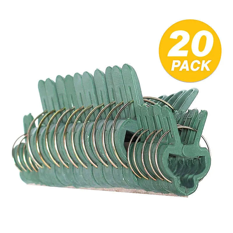 Green plastic and zinc plant fixing clips for supporting climbing tomato and cucumber vines.
