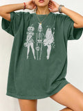 A loose-fitting black cotton t-shirt with short sleeves and a round neck on a hanger.