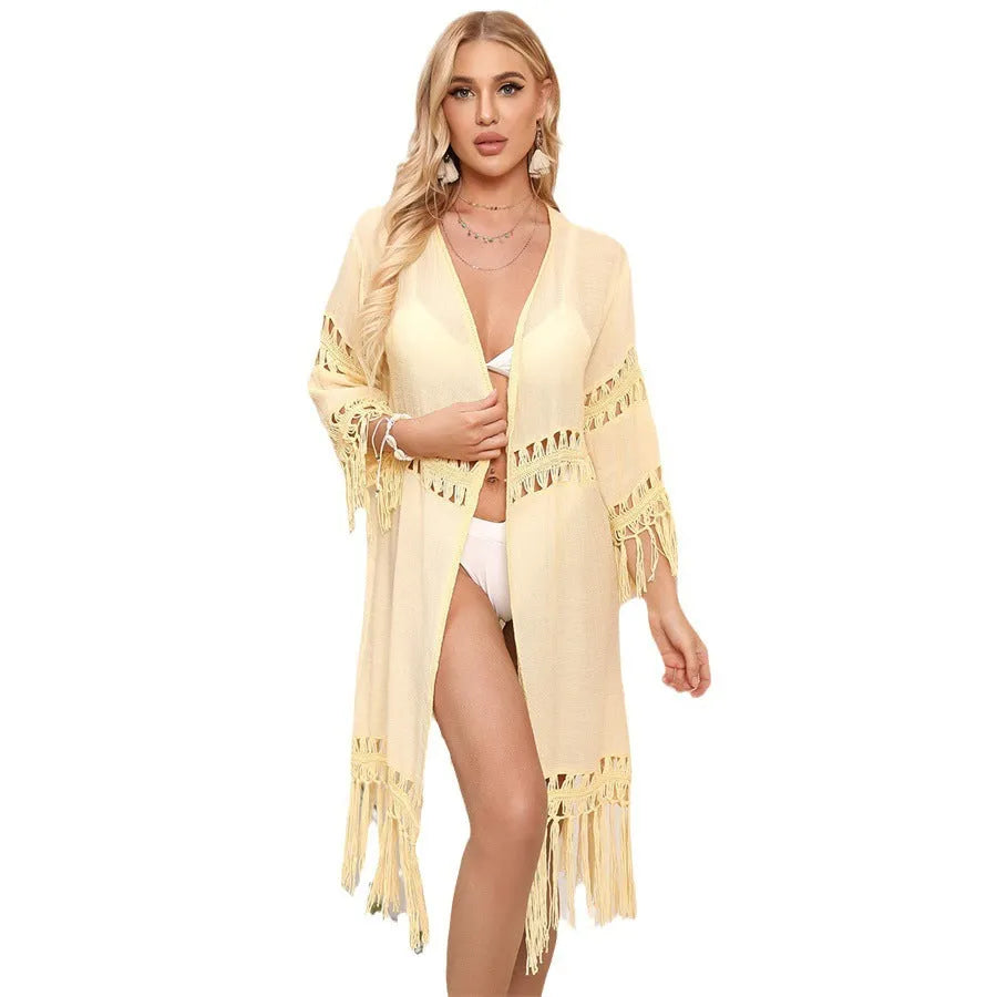 Women's yellow crochet cardigan beach cover-up with tassel details on mannequin