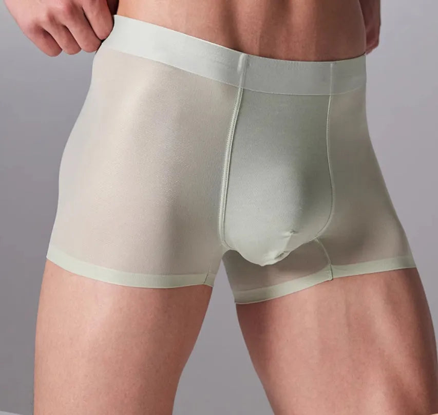 Seamless antibacterial fitness shorts in colours green, black, blue, and silver on a size chart.