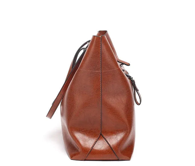 Brown waxed cowhide leather crossbody handbag showing front view with two compartments.