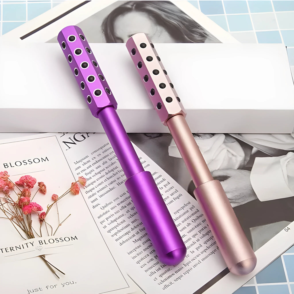 Purple germanium particle facial massage roller on a white background.