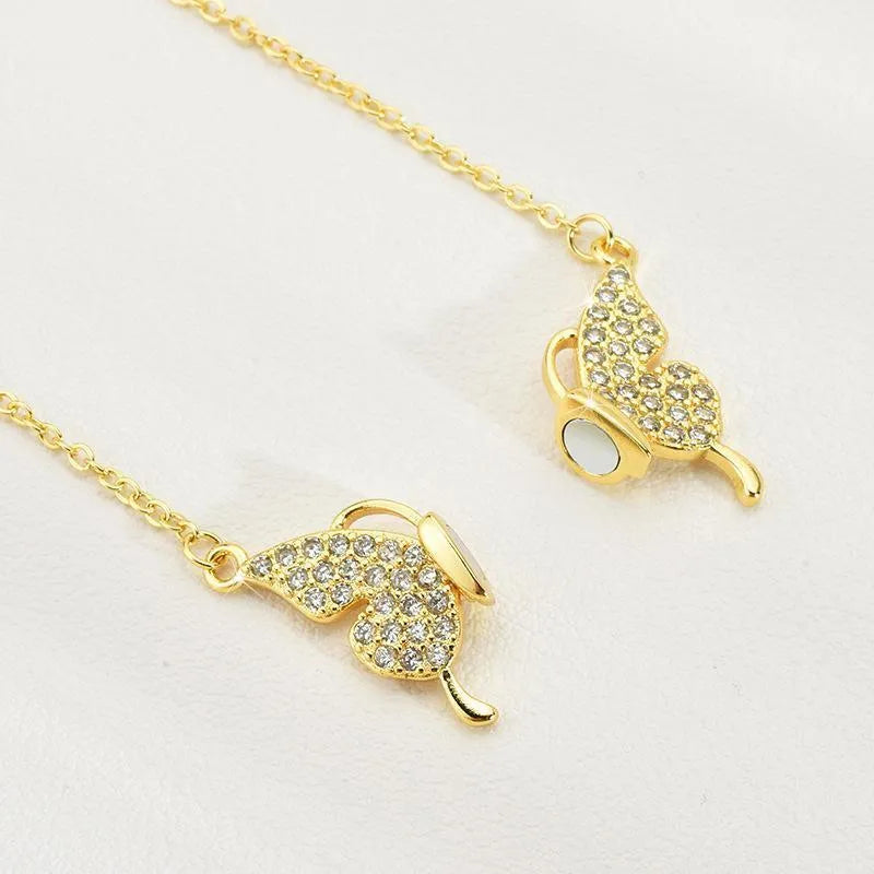 Women's clavicle necklace with butterfly pendant on twisted chain, showing magnetic snap closure