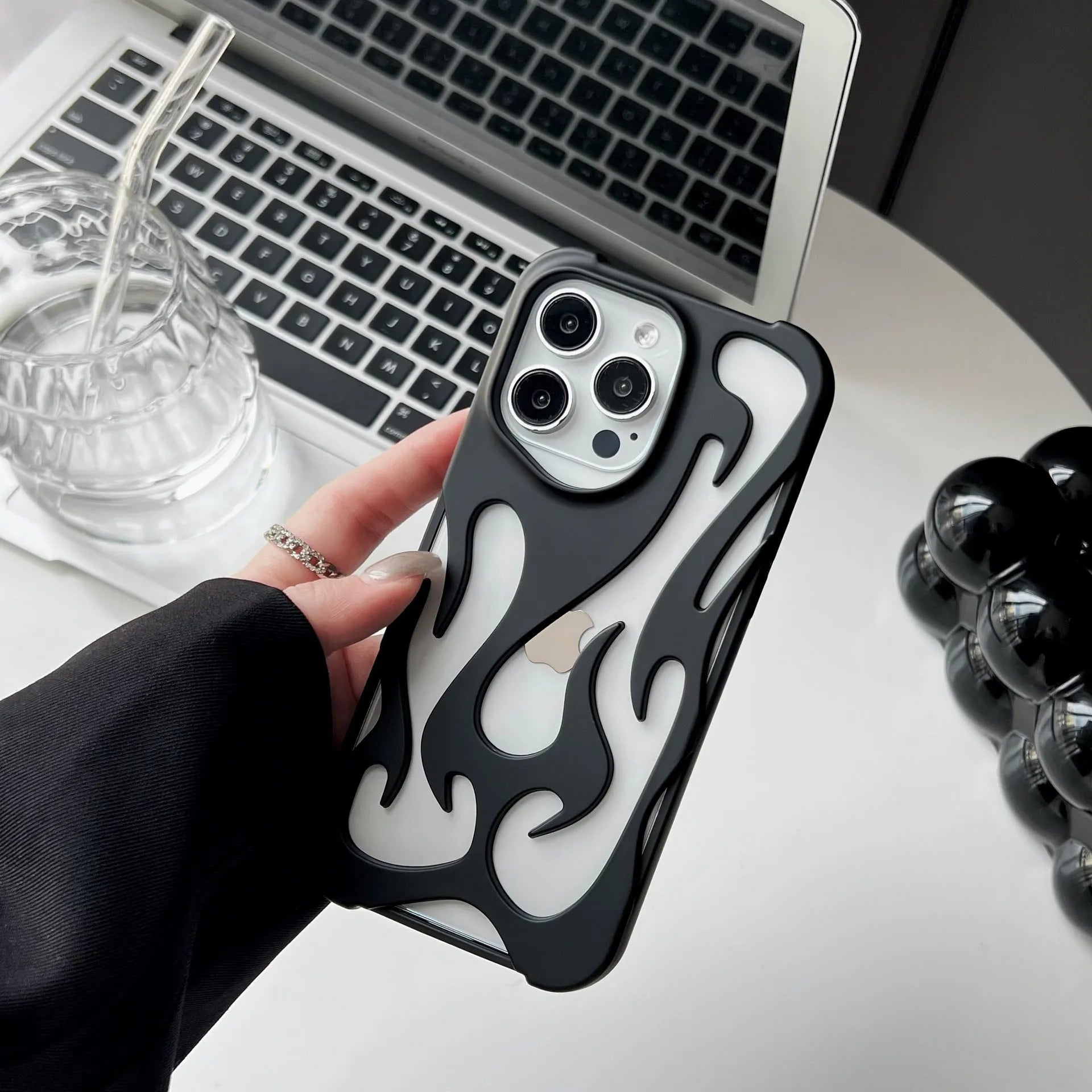 Electroplated hollow flame pattern phone case for iPhone, showing silver finish and perforated design for heat dissipation.
