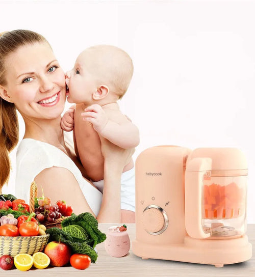 Green and pink baby food processor with steamer and blender functions, showing double mixing blades.