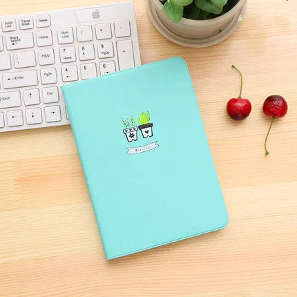 Leather handbook notebook 36K with 112 beige pages closed, showing blue red and white colour options