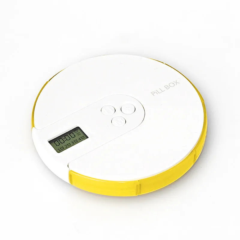 Blue seven-compartment electronic pill box with digital display and alarm clock, shown next to pills.