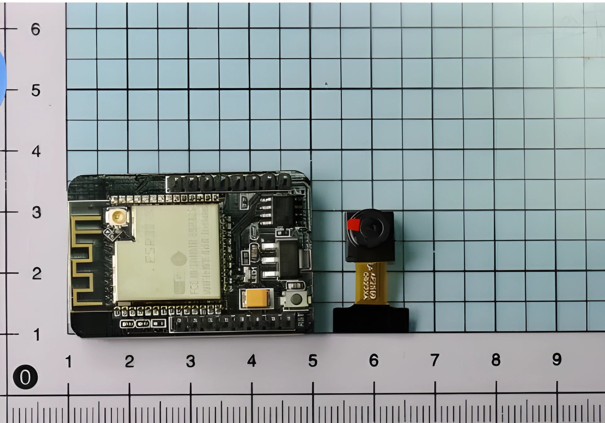 ESP32-CAM development board with OV2640 camera and WiFi Bluetooth module on a neutral background
