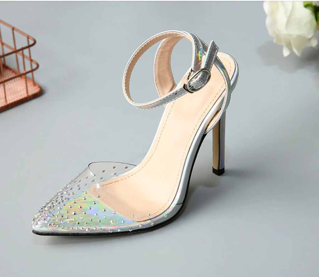 Women's pointed toe stiletto heel sandals with a glossy PVC upper and an ankle strap buckle.