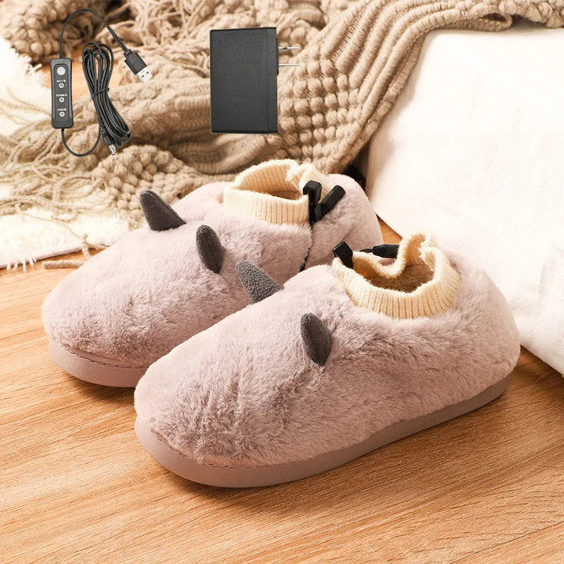 USB electric foot warmer slippers in grey with a connected USB cable on a wooden floor.