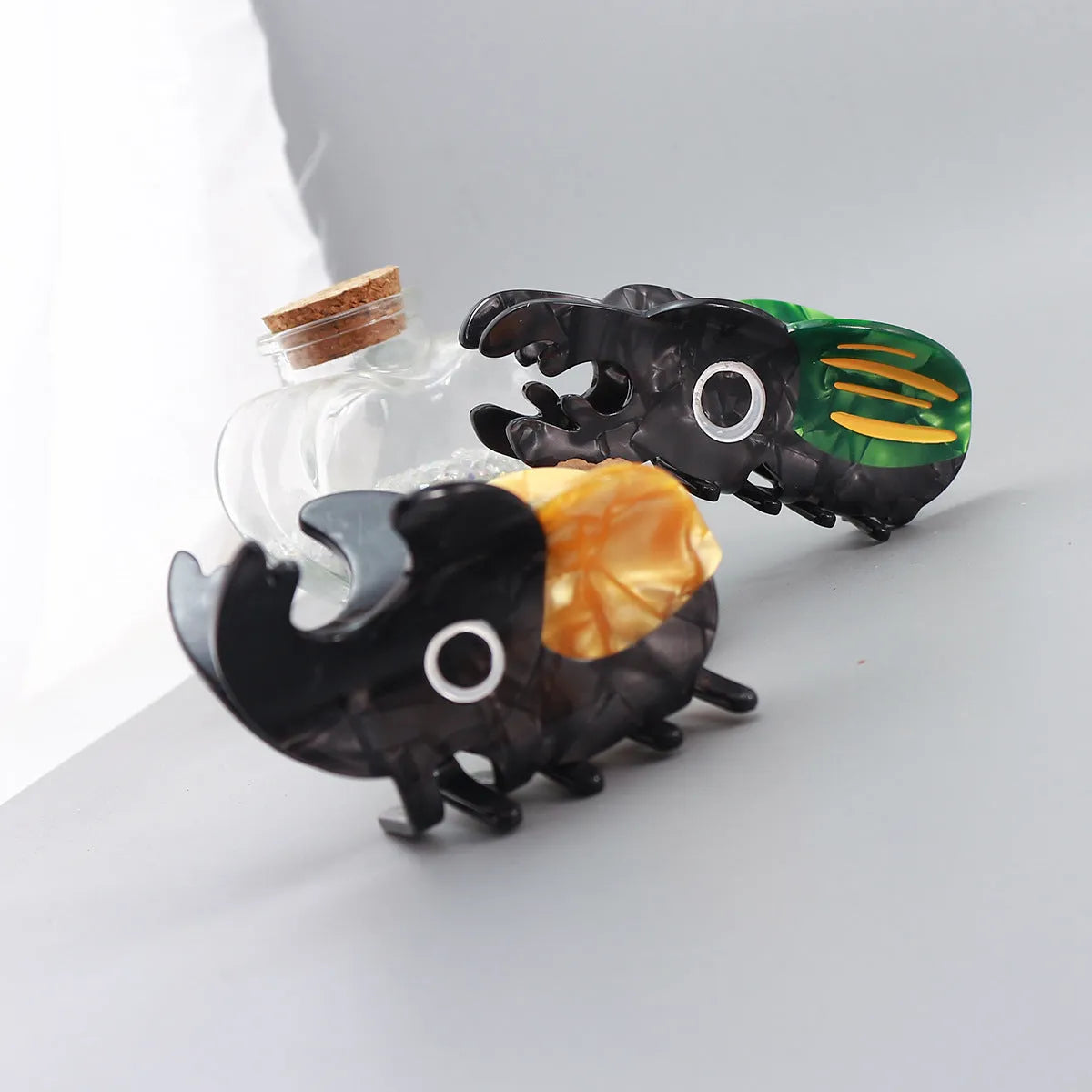 Handmade cellulose acetate beetle hair grip with cartoon caterpillar design in green, orange, or white colour options
