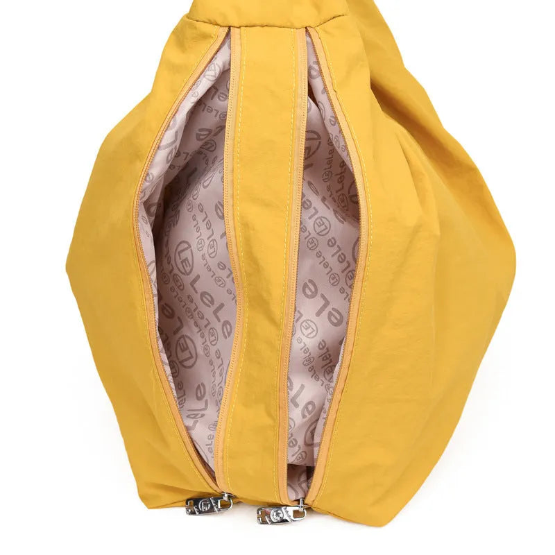 Women's heart-shaped nylon crossbody bag in black, shown from the front.