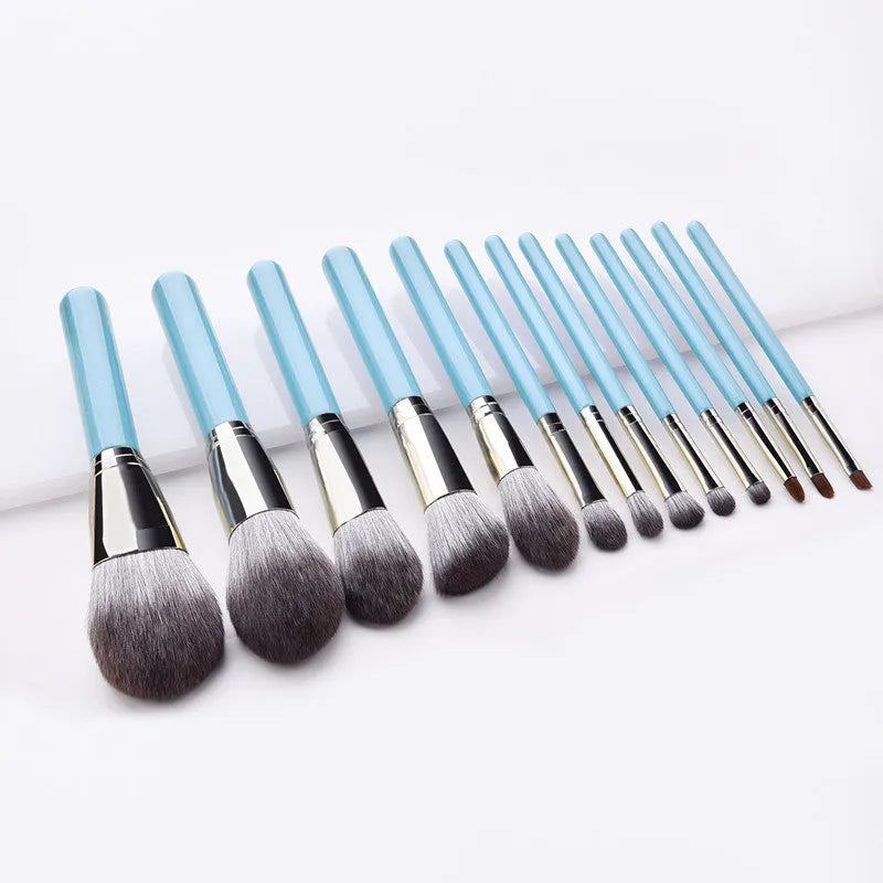 Blue 13-piece synthetic hair makeup brush set with wooden handles and aluminum ferrules on a clean surface