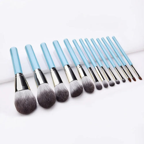 Blue 13-piece synthetic hair makeup brush set with wooden handles and aluminum ferrules on a clean surface