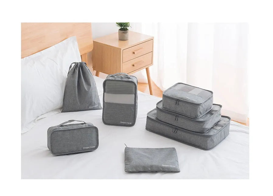 Set of 7 waterproof nylon travel tote bags in black, gray, dark blue, blue, and orange showing different sizes