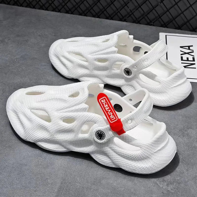 Men's grey EVA foam slippers with closed toe and thickened sole on a sandy beach.