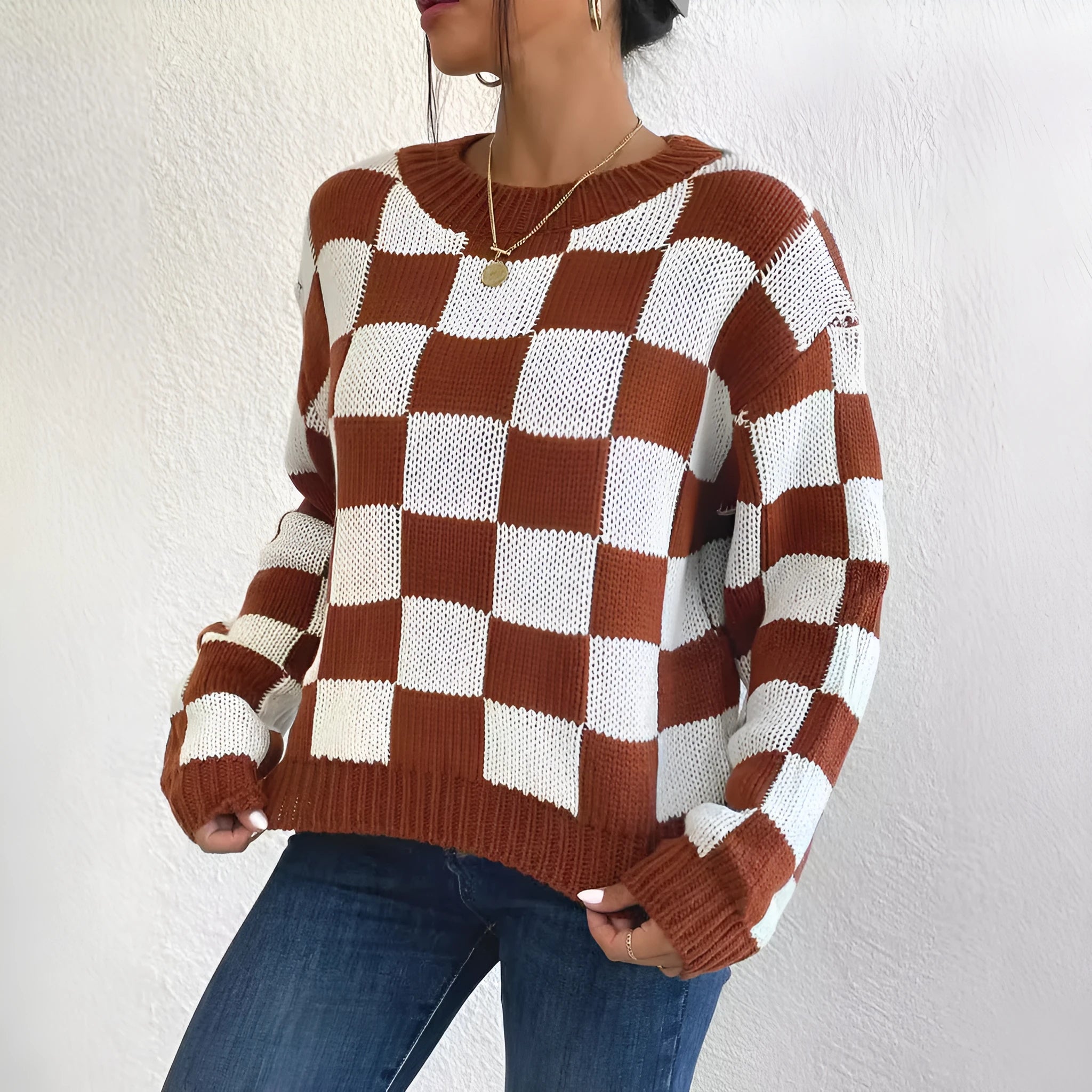 Dark brown plaid pattern acrylic pullover sweater with long sleeves and a round neck.