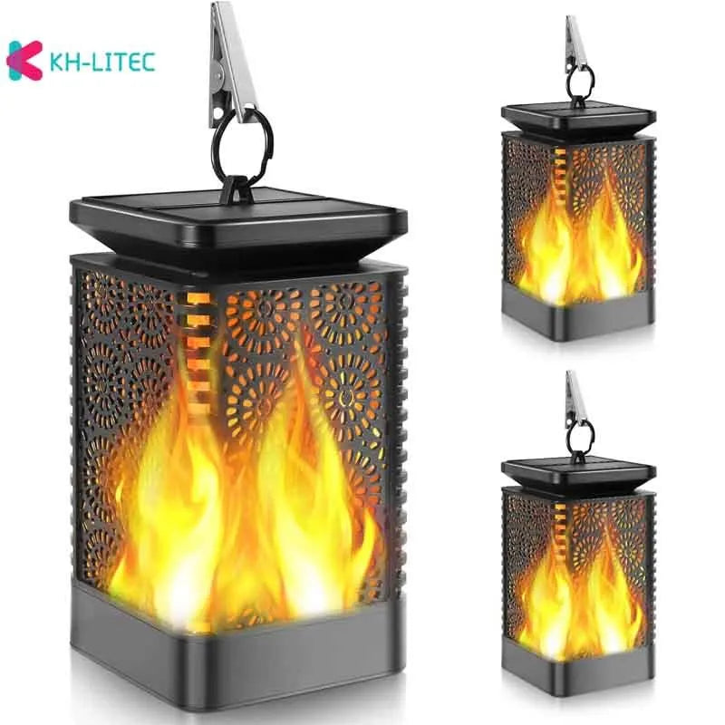 Set of four black solar-powered hanging torch lights with flickering flame LED for outdoor garden use.
