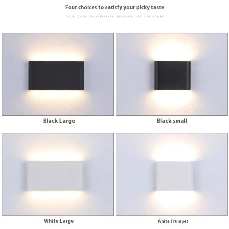 Rectangular LED outdoor wall lamp in black finish with warm light on a brick courtyard wall