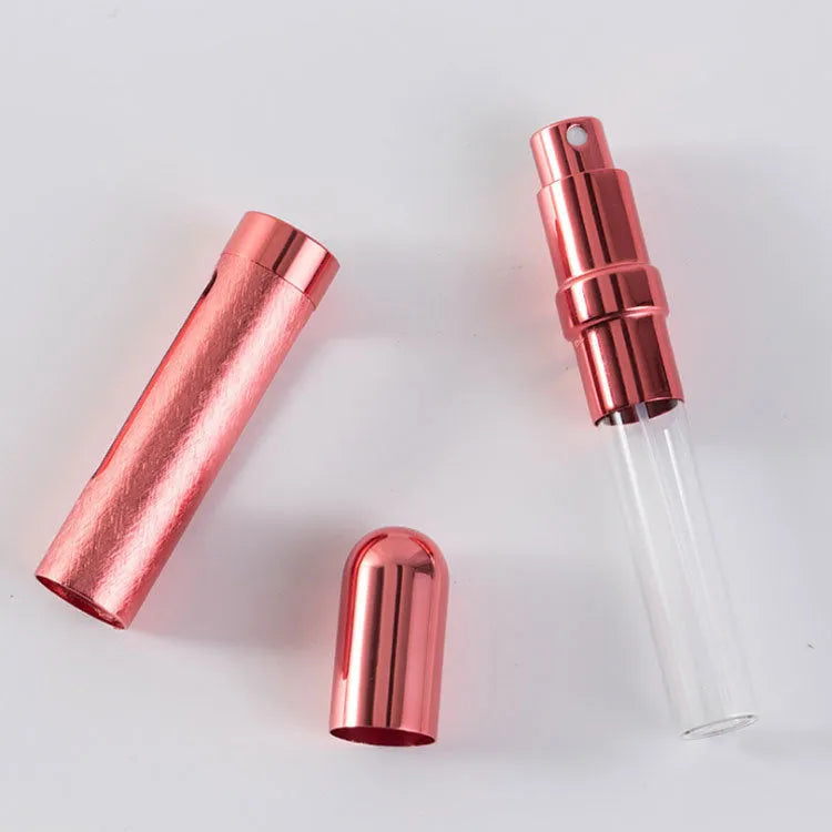 Refillable aluminium travel perfume atomiser with glass liner in blue, gold, pink, red, silver, or violet.