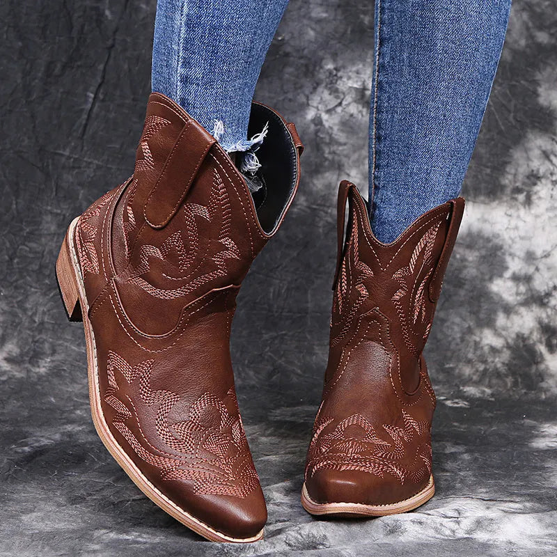 Women's blue embroidered Western ankle boots with a low wedge heel and pointed toe