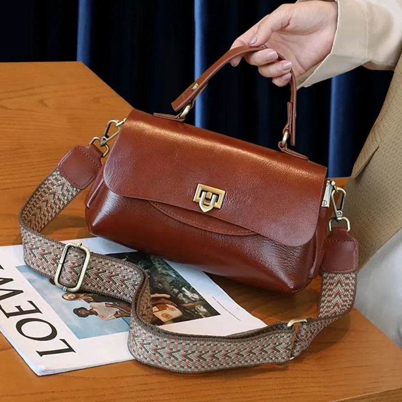 Brown retro style women's leather handbag with saddle back shape and double shoulder straps