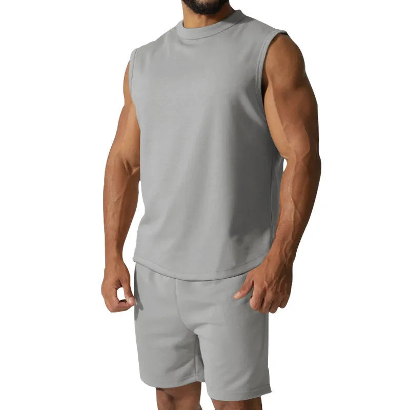 Men's sleeveless cotton blend sports top and matching shorts in a solid colour, laid flat.