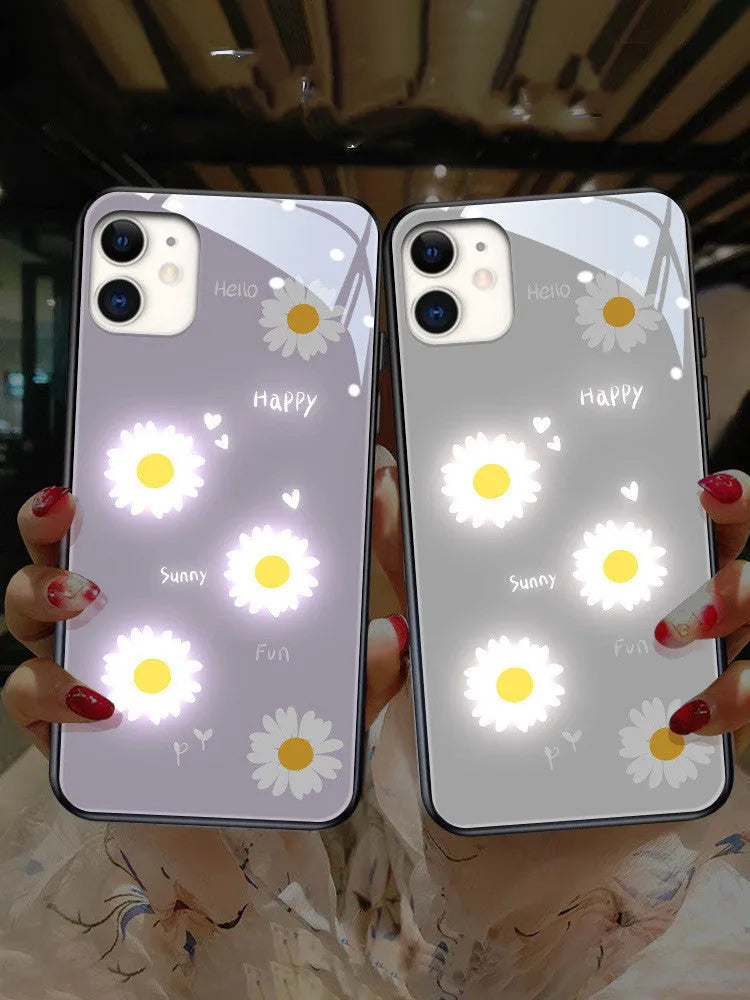 White iPhone case with painted purple daisy design and illuminated multi-colour LED lights around the edges.