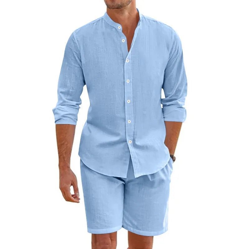 Men's dark grey linen-blend short sleeve button-down shirt and matching drawstring shorts on a beach