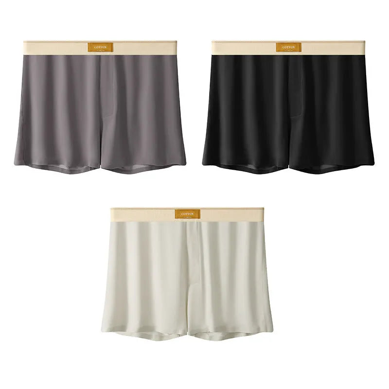 Pack of men's solid colour ice silk boxer shorts showing loose fit and mid-waist design.
