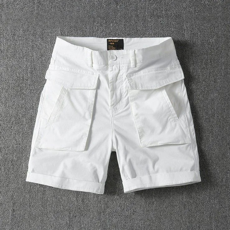 Men's straight-leg cotton cargo shorts in khaki with multiple pockets, shown on a model.
