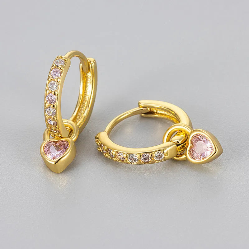Women's heart-shaped earclip earrings with a coloured zircon or stone centre, in gold or white gold colour.