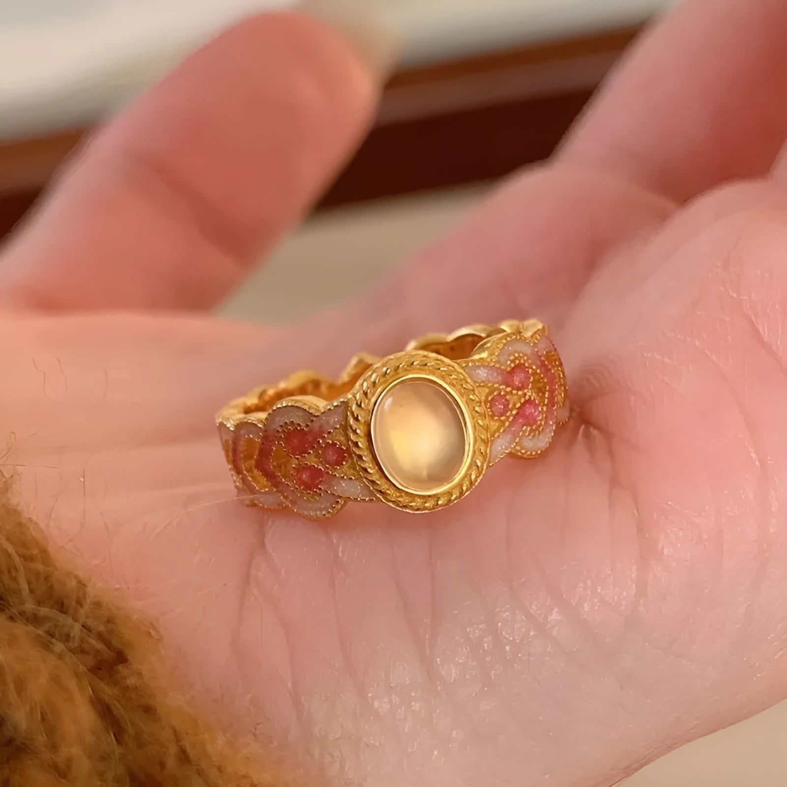Geometric open ring with pink crystal enamel on gold-plated copper band.