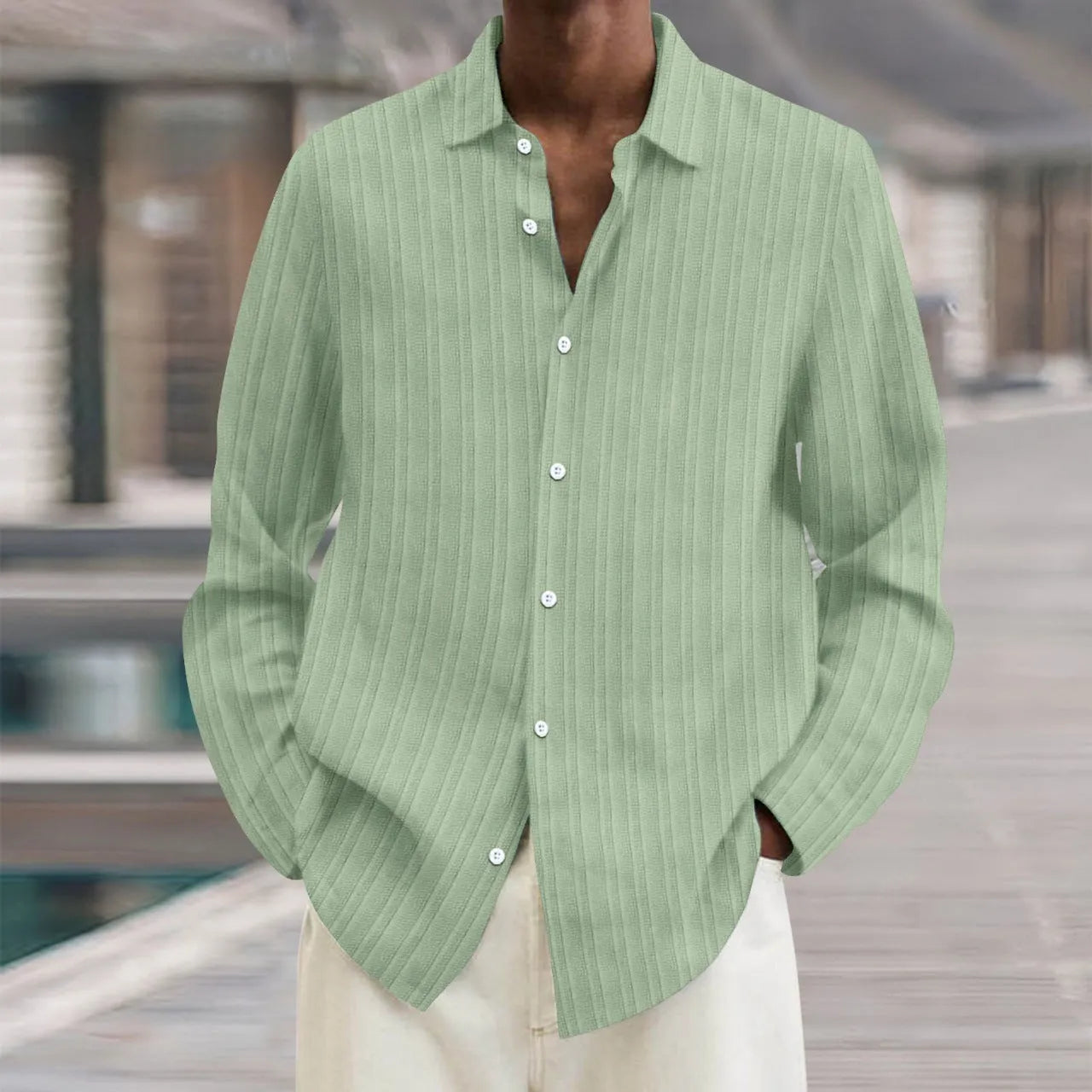 A man's loose-fit striped cardigan shirt with long sleeves in a British style design.