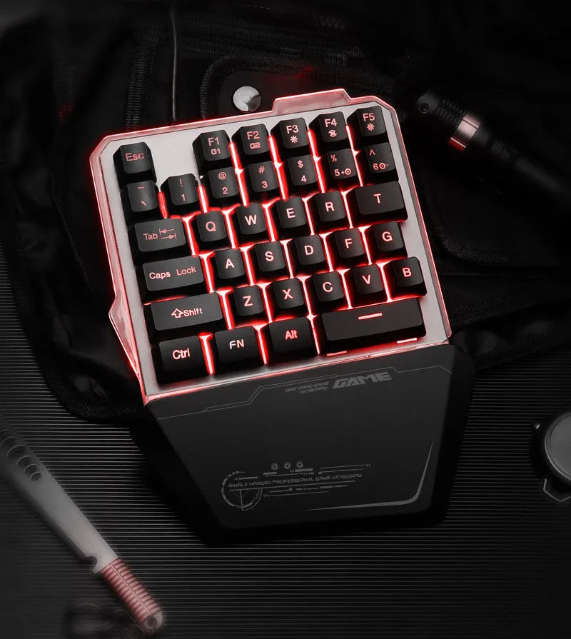 Black G40 Flow one-handed mechanical keyboard with RGB backlit keys on a desk