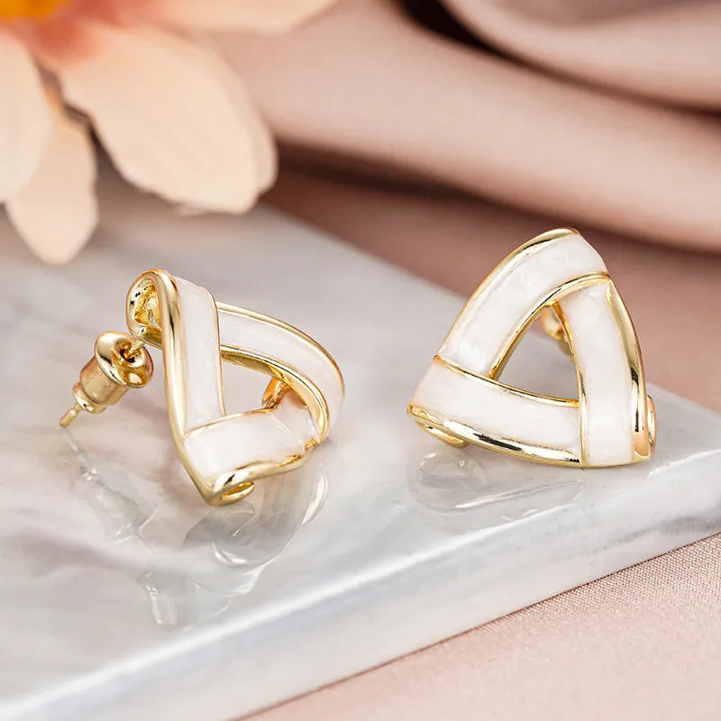 Women's metal oil stud earrings with inlaid zircon, geometric triangle shape, yellow gold finish on copper