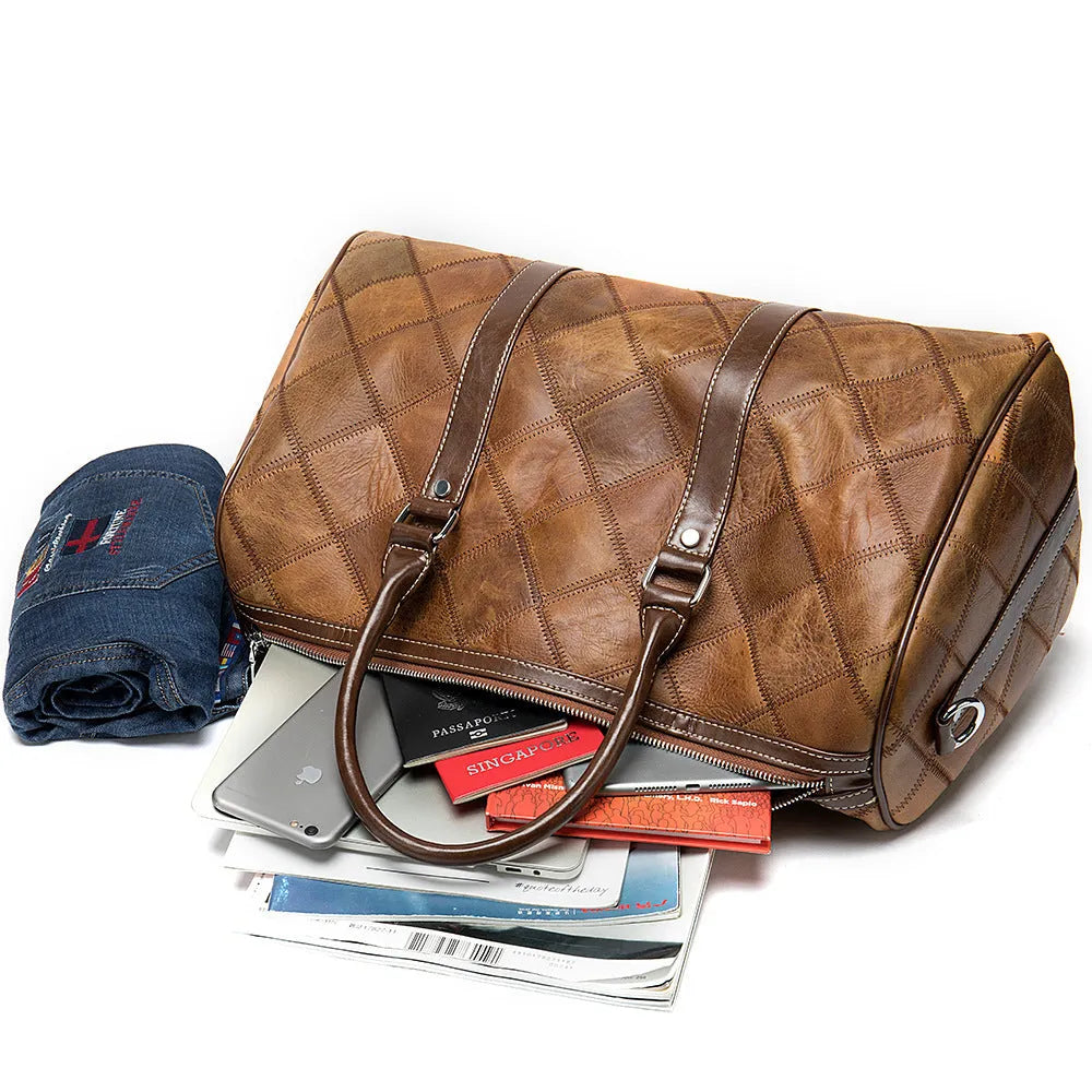 Vintage brown cowhide leather duffel bag with a single strap and internal organiser pockets.