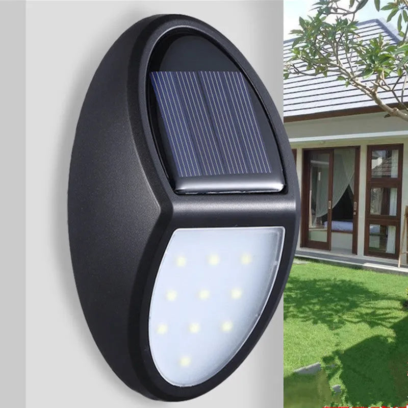 Black rectangular solar-powered LED wall light with a solar panel on top.