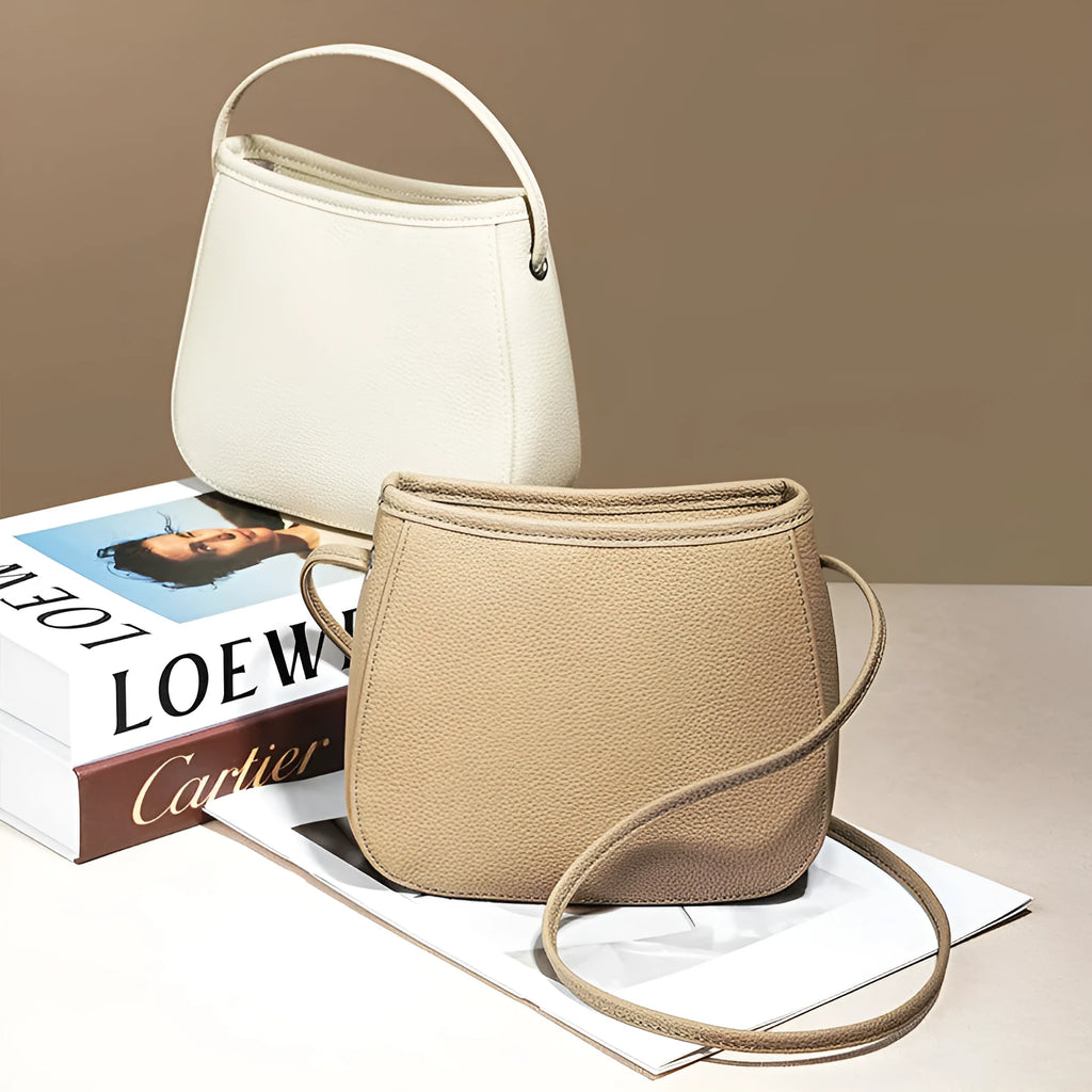 Soft genuine cowhide women's messenger bag in a square vertical shape with a loading handle.
