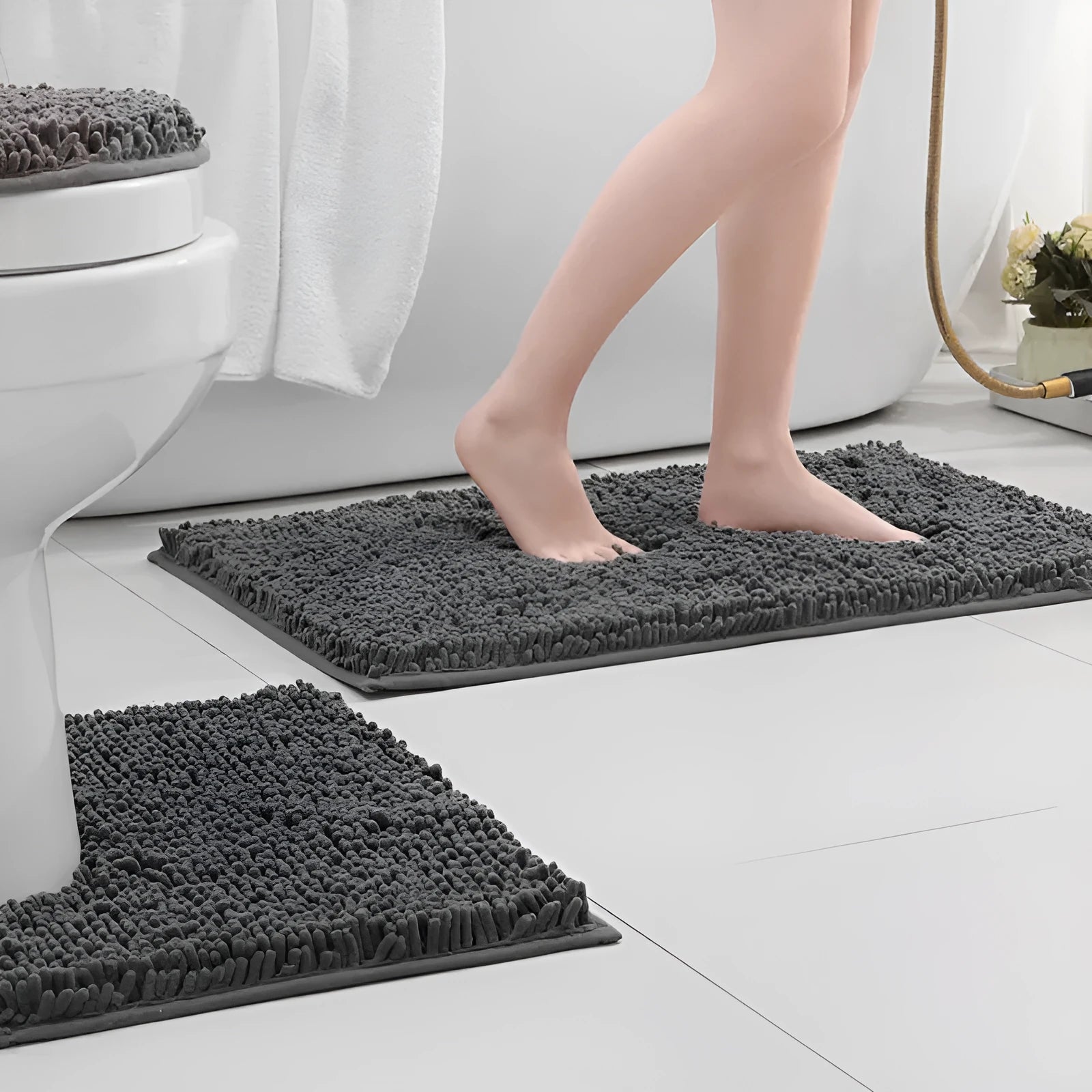 Dark green chenille U-shaped toilet mat with two matching rectangular bathroom mats on a tiled floor.