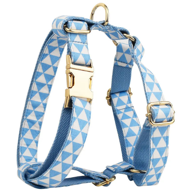 Blue cloth dog collar, lead, bow, and vest set laid out flat showing the four matching pieces.