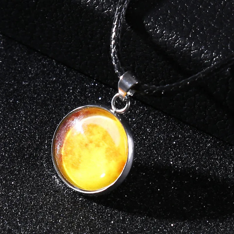 Luminous moon and star constellation pendant necklace with a silver-tone chain on a black background.